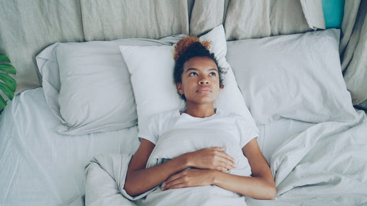 A person lying in bed awake due to an adrenaline rush