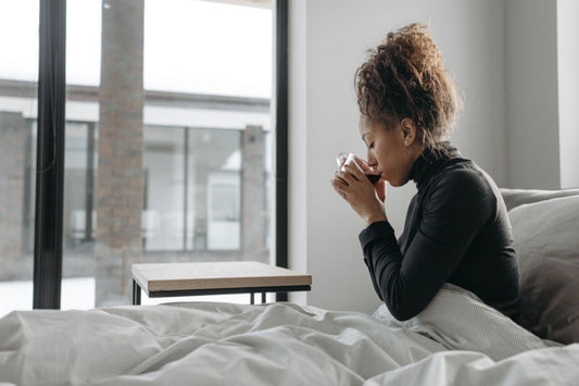 Woman sitting up, showing the unrefreshing sleep common in chronic fatigue syndrome